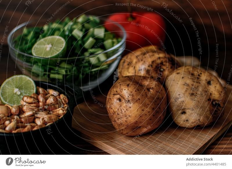 Assorted ingredients for chicken stock placed on table assorted cutting board potato raw various sprig onion cook food meal cuisine grain chop nutrition