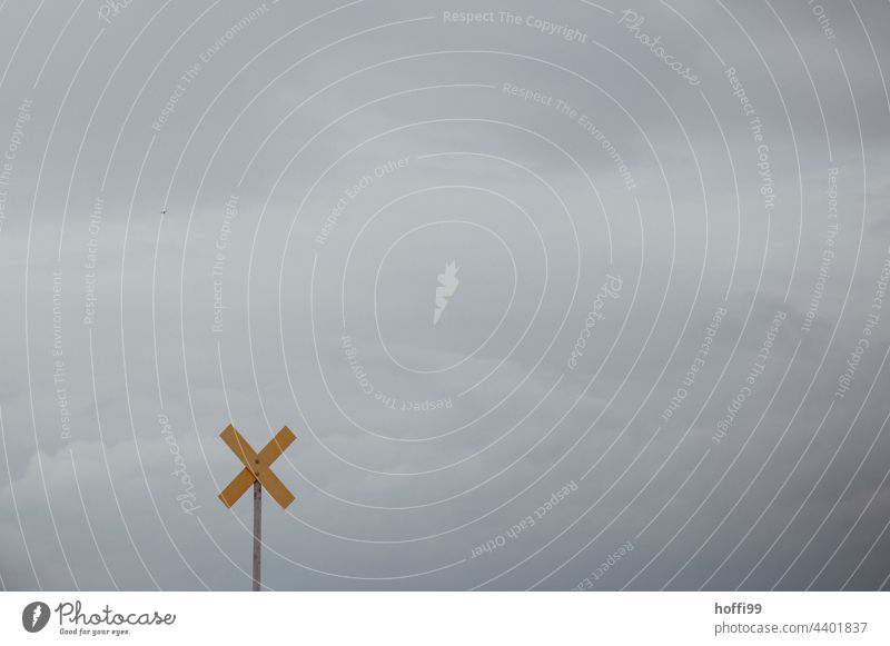 yellow cross against grey sky Yellow Crucifix Road sign Gray Bad weather Gale Storm clouds storm clouds