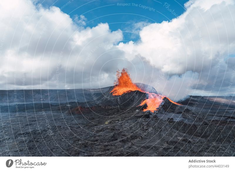 Active volcano under blue sky with cumulus clouds burn active erupt highland nature energy power fire cloudy dynamic landscape fagradalsfjall iceland scenic