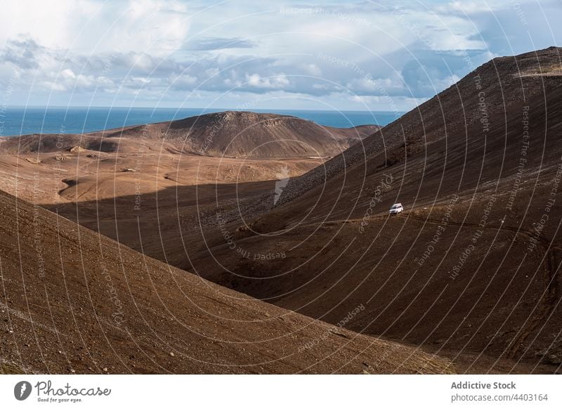 Mounts and volcano against sea under cloudy sky mountain nature highland landscape geology fagradalsfjall active erupt iceland scenic vehicle parked horizon