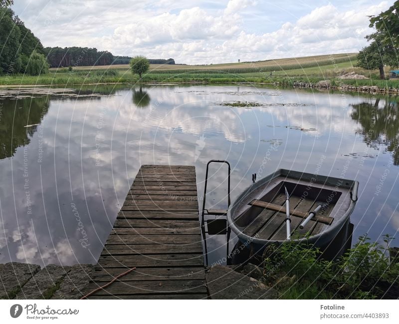 "A little piece of paradise" Fotoline thought to herself as she looked out at the rowboat by the small pond. "Do I stay on the dock or go for a ride?" Pond Lake