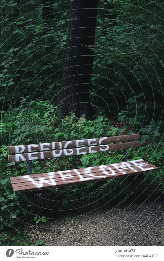 Refugees welcome | Lettering on a bench Graffiti Exterior shot Park Bench writing Characters Deserted Welcome human Humanity refugees welcome Hospitality