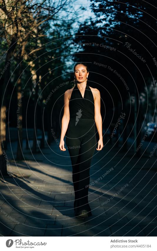 Delighted stylish woman standing in street style city trendy smile cheerful sunlight happy fashion female optimist joy delight charming summer content modern