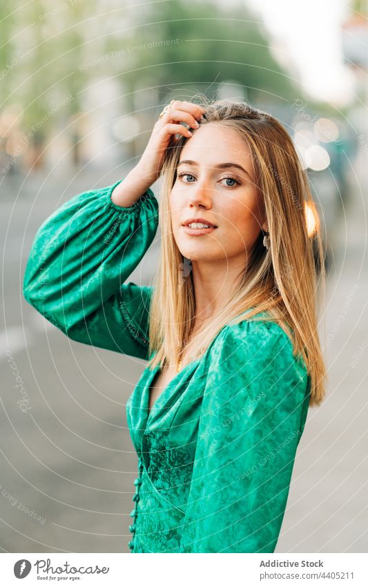 Happy woman in stylish green dress in city trendy fashion style outstretch carefree freedom female outfit summer urban charming street smile enjoy feminine