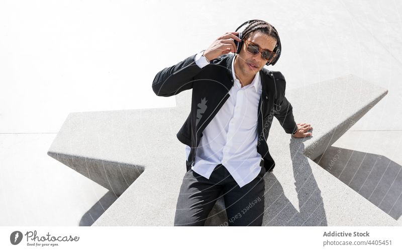 Happy businessman in headphones and sunglasses on street style happy trendy music enjoy urban carefree young ethnic braid african american black fashion modern