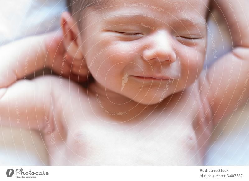 Cute newborn sleeping on bed baby infant cute lying innocent comfort naked adorable soft relax bedroom sweet tender gentle calm harmony serene quiet tranquil