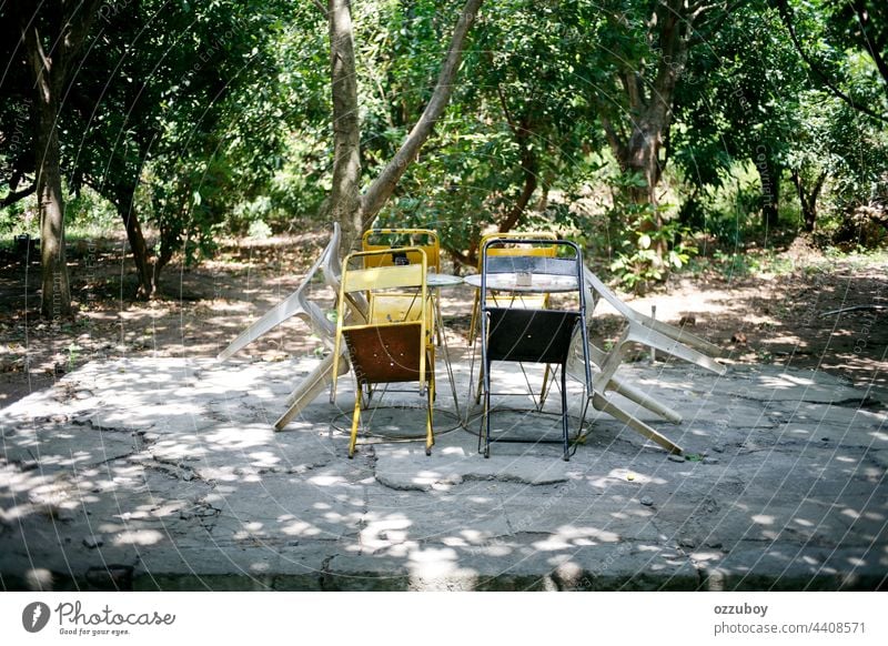 empty chairs and tables on park wood garden outdoor wooden furniture bench nature nobody background summer outside rest seat color green tree lawn scene white