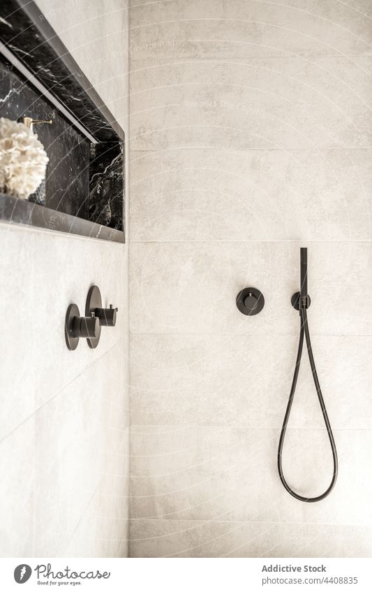 Shower cabin in modern bathroom with tiled walls shower interior minimal style black faucet handle hose design clean hygiene apartment simple plain home wash