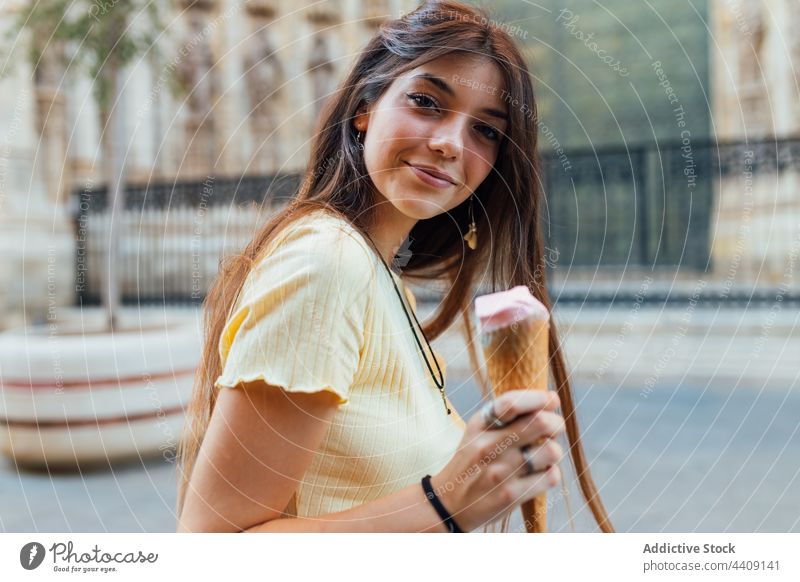 Crop happy woman with tasty ice cream cone in town smile dessert treat sweet portrait waffle delicious street crunchy gelato flavor yummy smooth creamy dairy