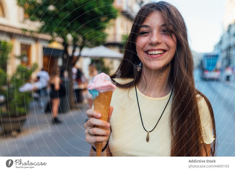 Crop happy woman with tasty ice cream cone in town smile dessert treat sweet portrait waffle delicious street crunchy gelato flavor yummy smooth creamy dairy