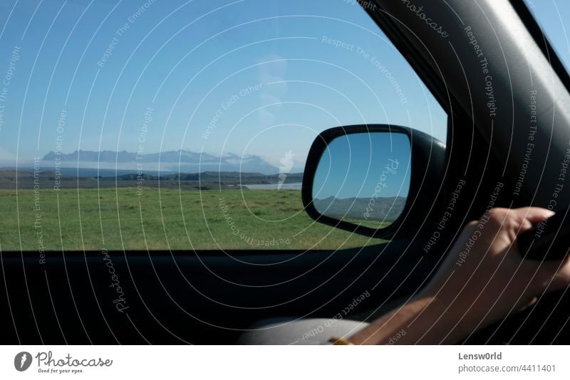 Road trip through Iceland with the landscape seen through the window and the mirror asphalt automobile background blue car drive green highway iceland icelandic