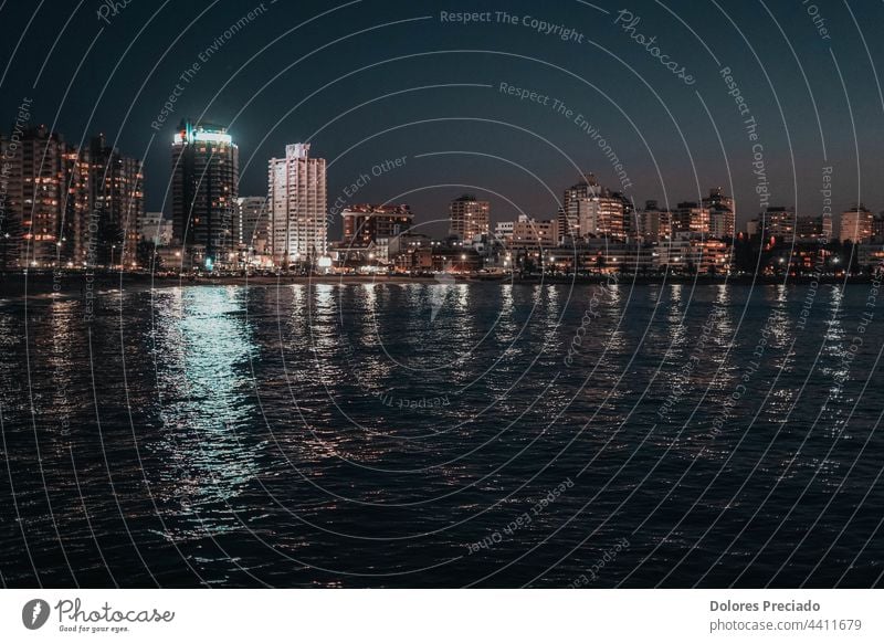 Night image of some buildings in a coastal city apartments architecture asia australia building group business business area business image capital capital area