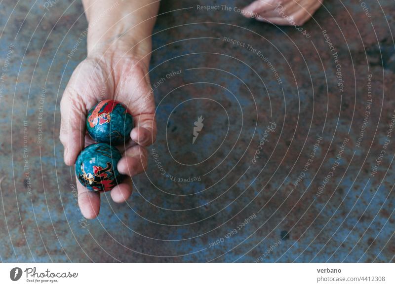 Hand of a person using chinese baoding balls to cure stress and excercise hands healthy finger lifestyle background care yin woman red alternative wellness