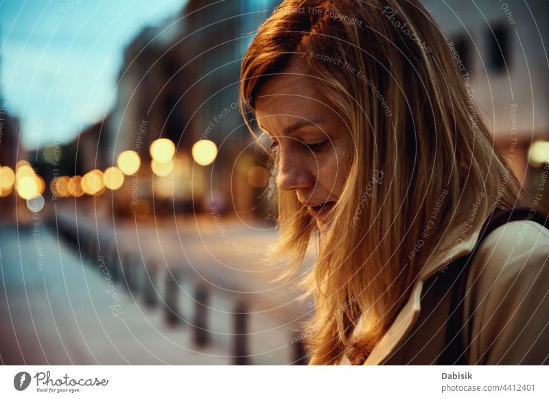 Woman at night city street woman portrait close up face busy sad business walk urban coat life city life look modern female caucasian travel work hair outdoor