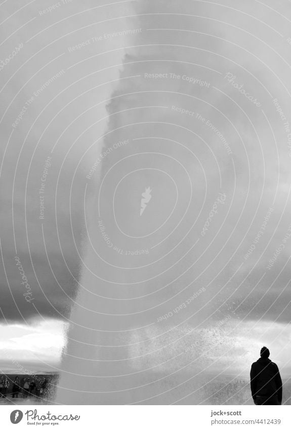 Eruption of the geyser with a spectator Geyser Nature Iceland Vacation & Travel Water Silhouette Tourist Black & white photo Sky Covered motion blur