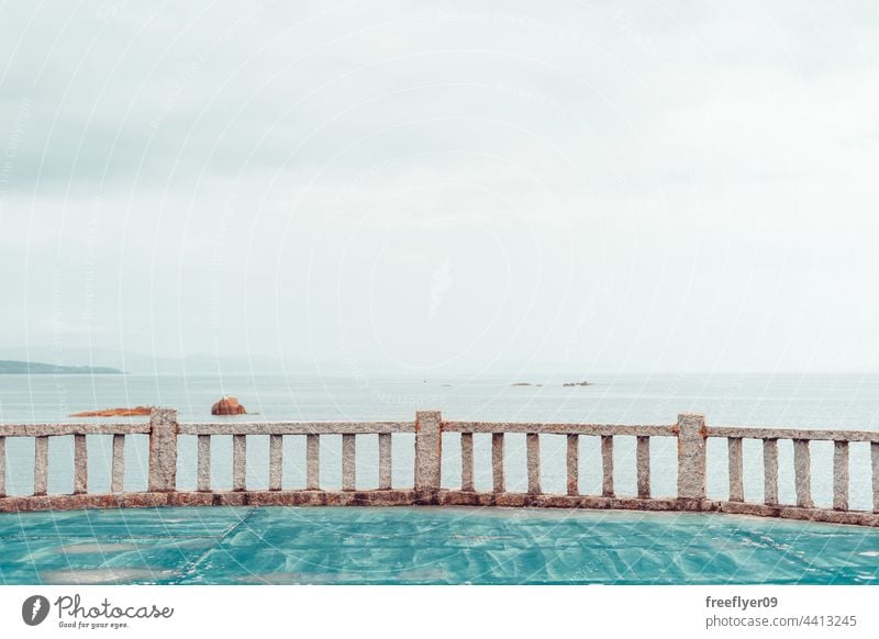 Stone railing near the ocean viewpoint islands stone walking path coastline horizon copy space nobody beach rock scenic landscape seascape water travel galicia