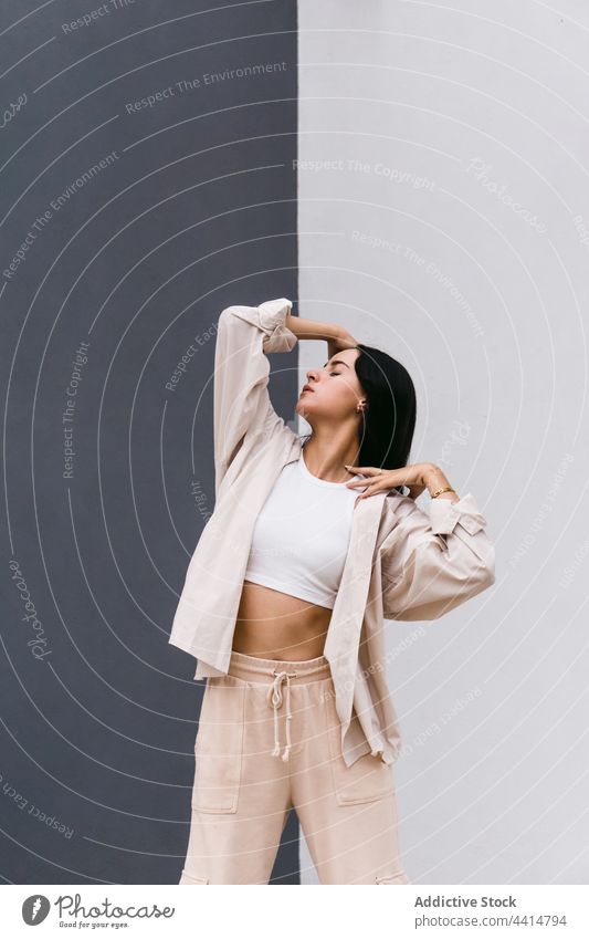 Flexible woman dancing near grey and white wall in city dance dancer perform street flexible choreography move female grace talent urban lean skill style energy