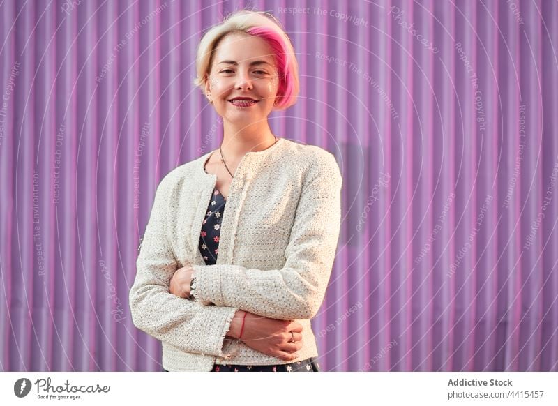 Informal woman with dyed hair on purple background in city informal smile appearance style urban trendy subculture female outfit street modern individuality