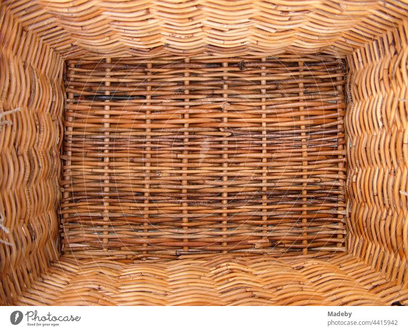 Classic bicycle basket made of beautiful brown wickerwork on a ladies bike in Oberammergau in the district of Garmisch-Partenkirchen in the Ammergau Alps Nature Park