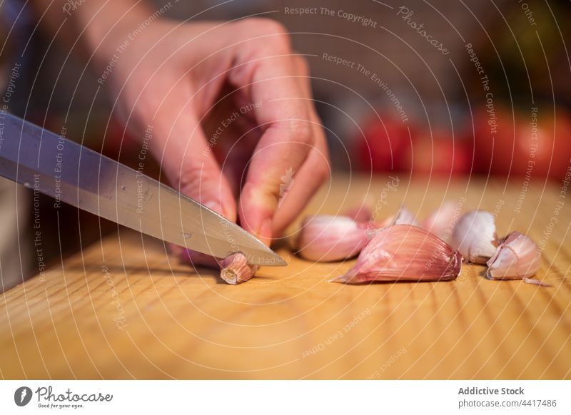 Crop woman cutting garlic at table chop cook cutting board food prepare kitchen knife female ingredient chopping board healthy food fresh housewife cuisine home