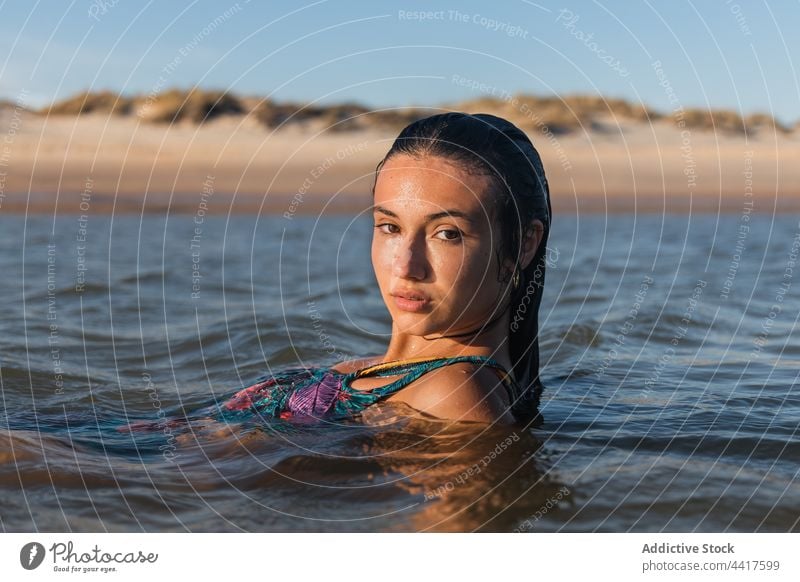 Charming woman swimming in sea in sunset water wet hair charming summer tranquil carefree female calm serene enjoy idyllic quiet paradise dreamy recreation