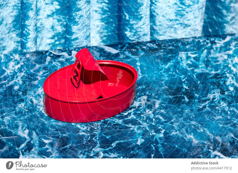 Red metal tin placed on table in studio can preserve conserve empty red color assorted concept different creative set design bright shiny vivid vibrant fresh