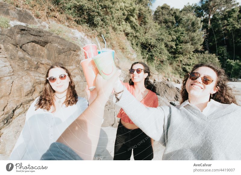 Happy young women laughing and smiling at the beach on a summer day, enjoying vacation, concept of friendship enjoying the outdoor party happiness people group