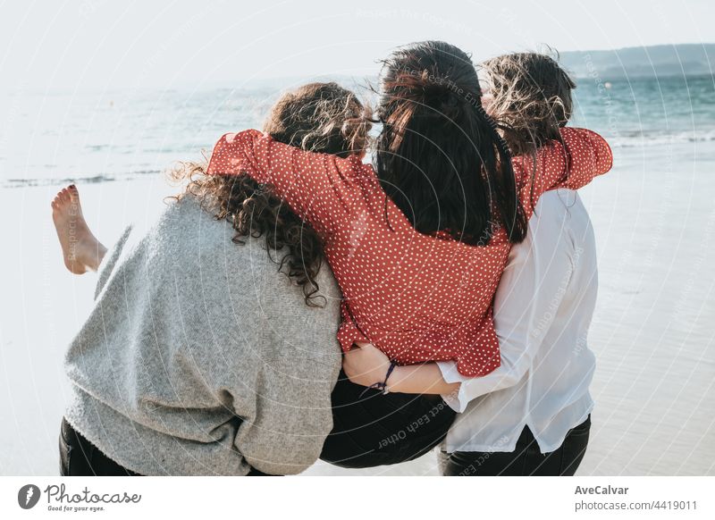 Happy young women laughing and smiling at the beach on a summer day, enjoying vacation, concept of friendship enjoying the outdoor party happiness people group