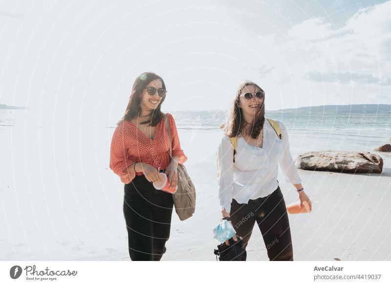 Happy young women laughing and smiling at the beach on a summer day, enjoying vacation, concept of friendship enjoying the outdoor party happiness people group