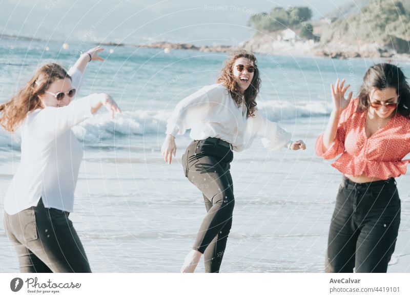 Happy young women laughing and smiling at the beach on a summer day, enjoying vacation, concept of friendship enjoying the outdoor party happiness people group