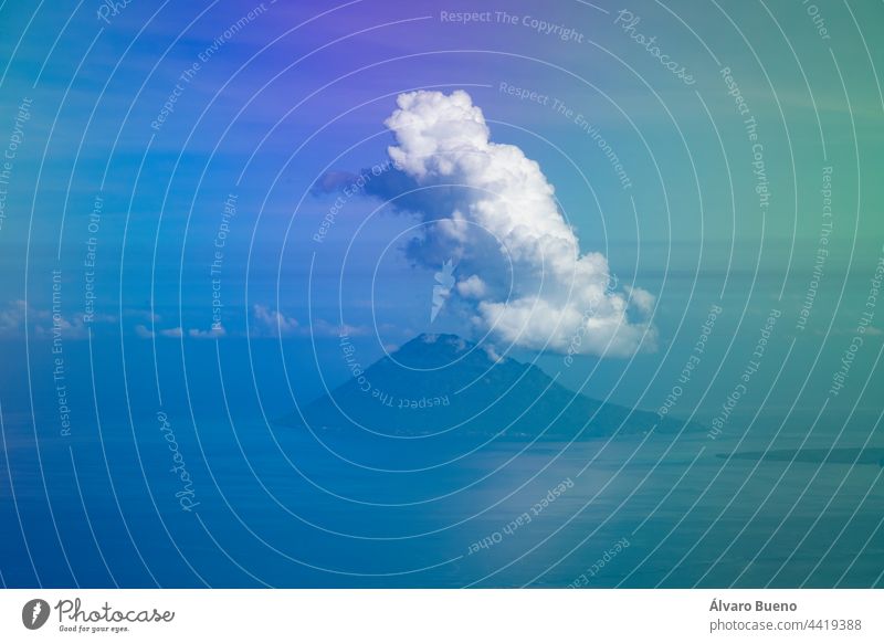 Aerial view from the plane, of the clouds clinging to the top of Manadotua Island, in Bunaken National Park, Sulawesi Island, Indonesia Manado Tua Dua