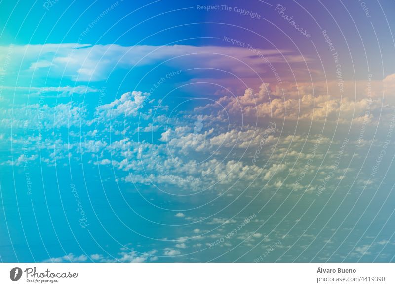 Aerial view from the plane, with strange colors, of a landscape of clouds and distant islands, flying over the island of Sulawesi, Indonesia North Sulawesi