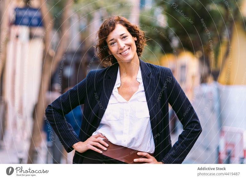 Smiling woman in formal outfit relaxing walking away enjoy elegant style chill sunlight positive carefree street urban city female worker pleasure optimist