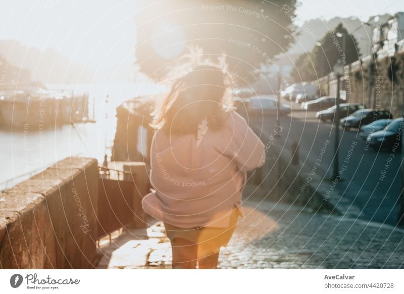 Woman out of focus running during a super red sunset in the city, tourism concept window one person real people young adult caucasian ethnicity human face