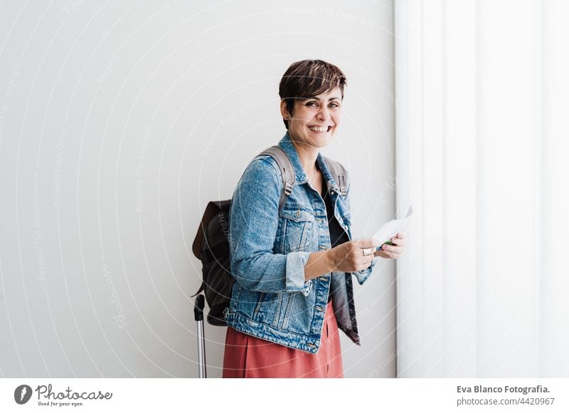 happy backpacker caucasian woman at train station holding ticket waiting to catch train. Travel concept travel public transport young suitcase luggage baggage