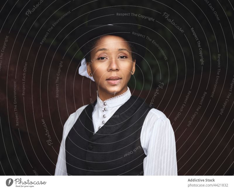 Confident black lady near horse in countryside woman jockey confident portrait serious stare horsewoman emotionless female african american adult elegant light