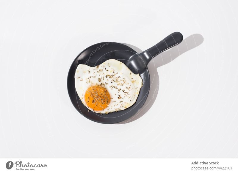 Tasty fried egg on skillet in white table tasty minimal delicious meal food dish cuisine nutrition serve yummy fresh breakfast healthy portion gourmet culinary