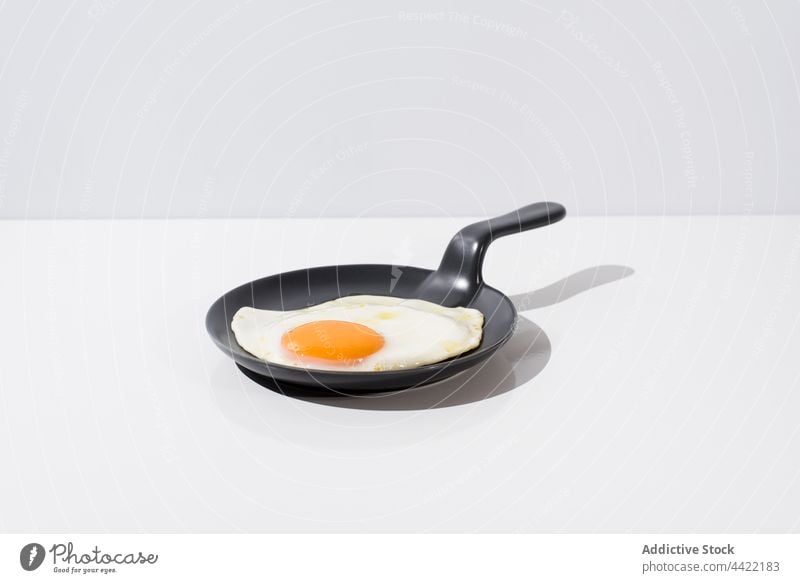 Tasty fried egg on skillet in white table tasty minimal delicious meal food dish cuisine nutrition serve yummy fresh breakfast healthy portion gourmet culinary