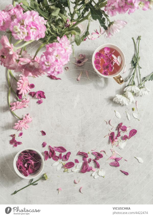 Cup with pink flowers tea on light desk with peonies flowers bunch and petals . Top view. Frame cup top view frame beautiful benefit beverage bloom blooming