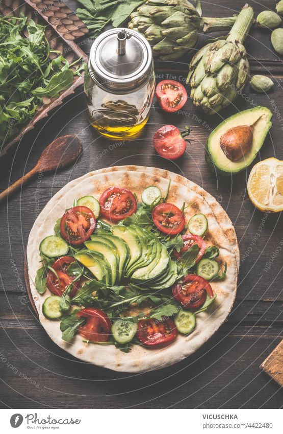 Preparation of vegan flatbread sandwich with avocado and other vegetables. Top view.  Healthy lunch preparation top view healthy lunch burrito cuisine fajita