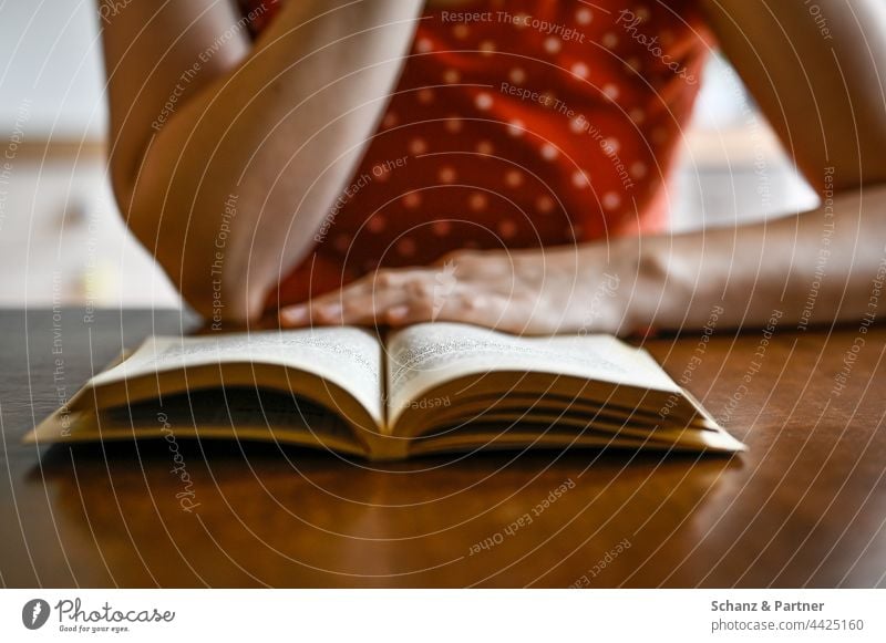 Woman reading a book at the table Reading Book books Hand hands pages To leaf (through a book) hollowed Literature bookshop library Reading matter Novel