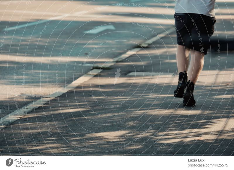 Shadows, lines, and a man walking hurriedly in the direction of the clue arrow Sunlight sunshine Bright Flashy Contrast Summer Lane markings Back-light Town