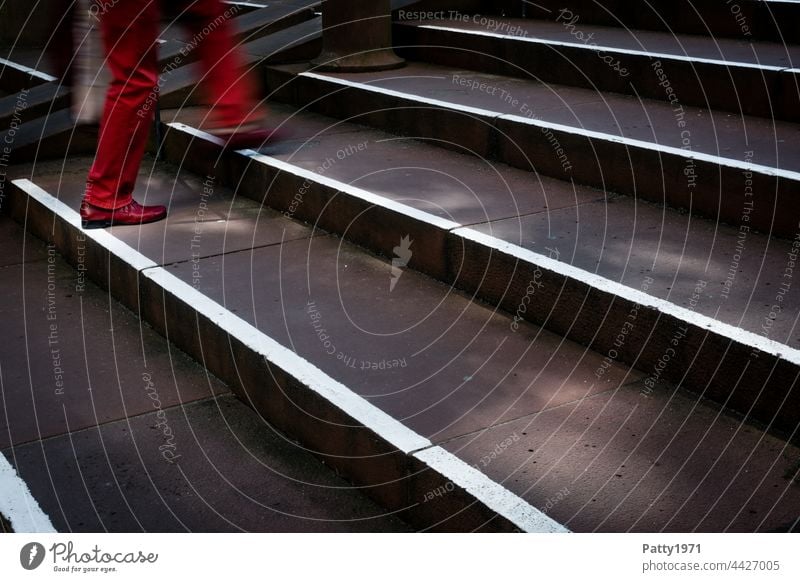 pedestrian in red trousers and shoes climbs a staircase - close up of legs Pedestrian Town Human being Stairs motion blur Going Shadow Light Exterior shot