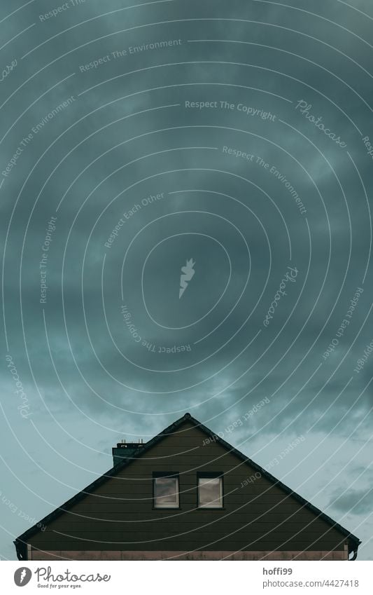 Storm clouds over the roof of a house thundercloud Threat Rain somber storm front Hail lightning bolt Thunder storm clouds Dark Weather Clouds