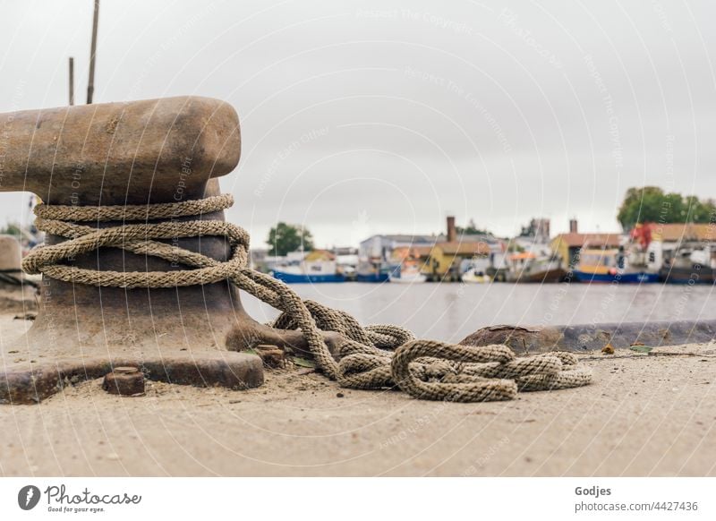 Rope around an anchor point at Freest harbour, boats at anchor in the background Harbour freest Water Ocean Navigation Watercraft Blue coast Tourism Summer Sky