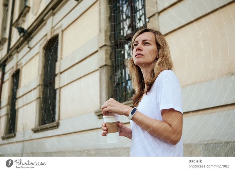 Woman walks at city street with paper coffee cup. woman drink casual relax freedom business girl urban model road person tea holding lifestyle takeaway