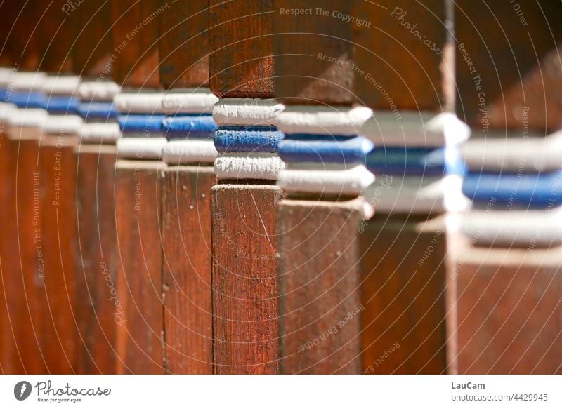 Diagonal - wooden pillars with coloured stripes are lined up in a row rail piers poles rank and file Row Forms and structures tidied Wood wooden struts