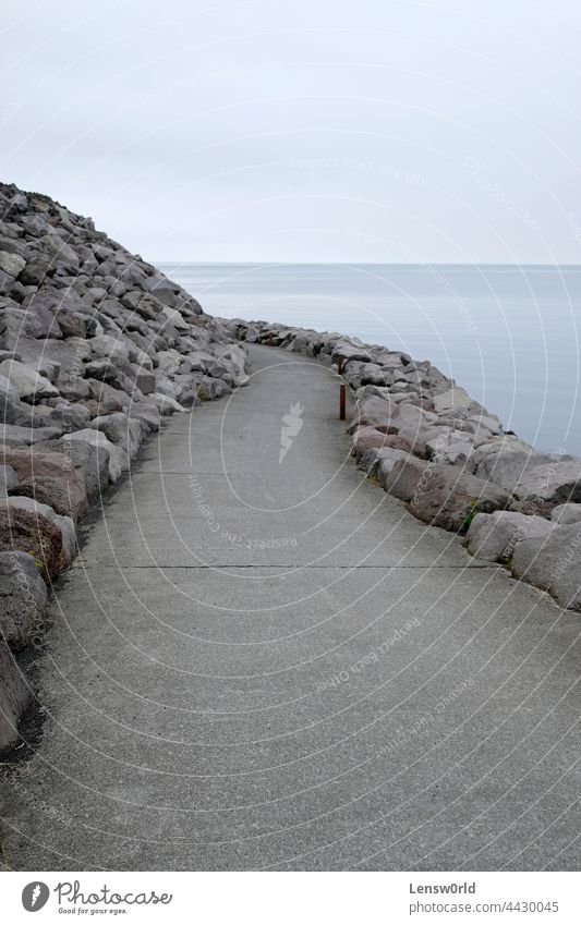 An empty path leading around a curve at the coast of Keflavík, Iceland background beach beautiful blue calm coastline iceland keflavik keflavík landscape nature