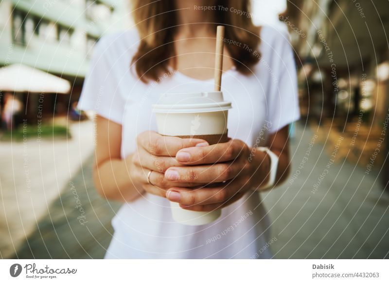 Woman walks at city street and drinks coffee to go woman cup paper casual relax freedom business girl urban model road person tea holding lifestyle takeaway