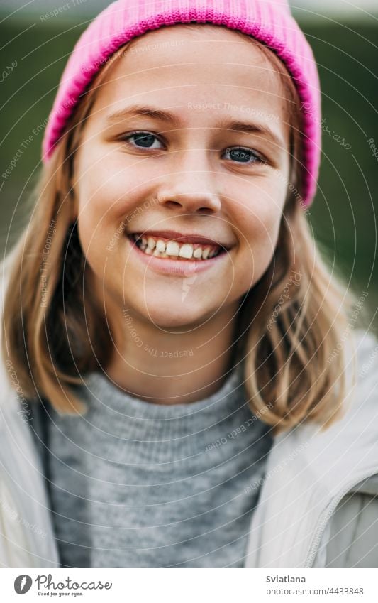 Portrait of smiling stylish teenage girl wearing pink fashion cap autumn yellow cornfield teenager cloak laugh lifestyle play cute rural plant nature harvest